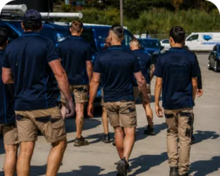 Plumbers walking to their service vans on a Camden South job